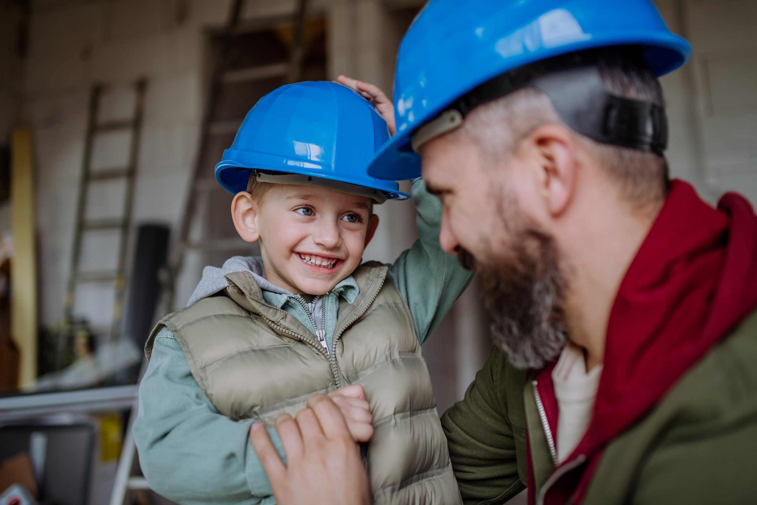 father-and-his-little-son-cuddling-in-their-unfini-2024-10-18-08-56-42-utc